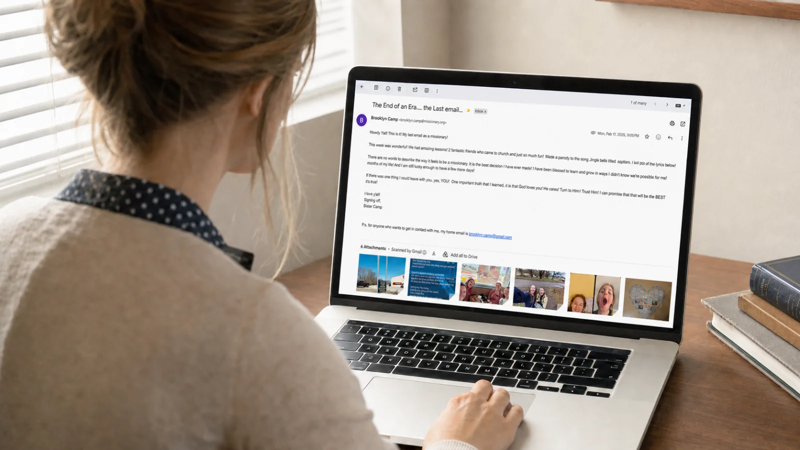 A woman working on a laptop at a dining table, organizing emails at home